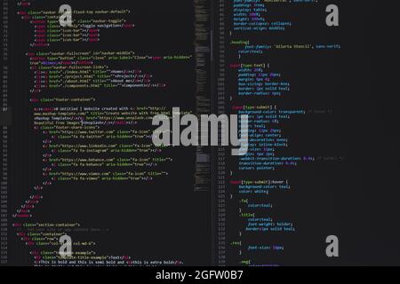 developer python, java script, html, css source code on monitor screen. writing script of software developer. program coding. programmer editing code Stock Photo