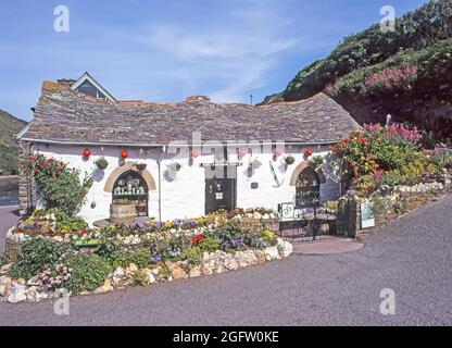 Archive view of picturesque1996 historical 1990s riverside Grade II Listed Building The Harbour Light Pixie souvenir shop with garden flowers converted from stables opening as a touristy gift shop beside River Valency seen on left later destroyed in 2004 flood & rebuilt as tea room an archival image from the way we were in the 90s in Boscastle Cornwall England UK Stock Photo