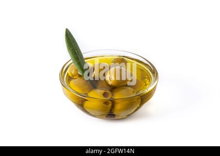 Green olives in a transparent bowl isolated on white background Stock Photo