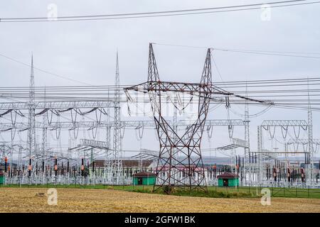 Distribution electric substation with power lines and transformers. High voltage power transformer substation. Stock Photo