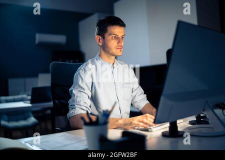 Business Analyst Businessman Working Late On Computer In Office Stock Photo