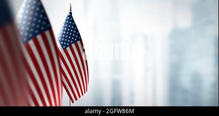 Small flags of United States on the background of a blurred background Stock Photo