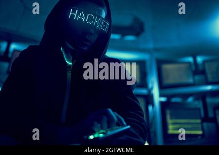 Cyber hacker breaks into databases to obtain information using a computer. Cybercrime and data security concept. Stock Photo