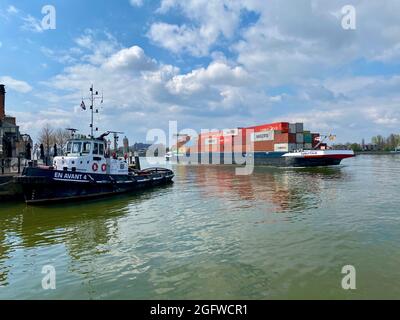 Inland barge freight shipping transport sailing pass Dordrecht in Holland in the Netherlands on calm river water of the Maas 2 Stock Photo