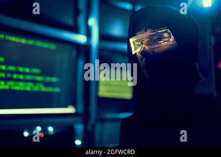 Cyber hacker breaks into databases to obtain information using a computer. Cybercrime and data security concept. Stock Photo