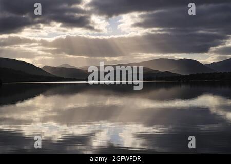 Sunrays and backlit clouds over Loch Tulla, Rannoch Moor, Scottish Highlands, United Kingdom, Scotland, Perthshire, Rannoch Moor Stock Photo