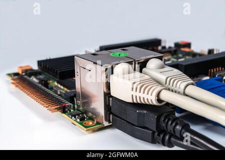 embedded cpu board with attached interface cables on white background Stock Photo