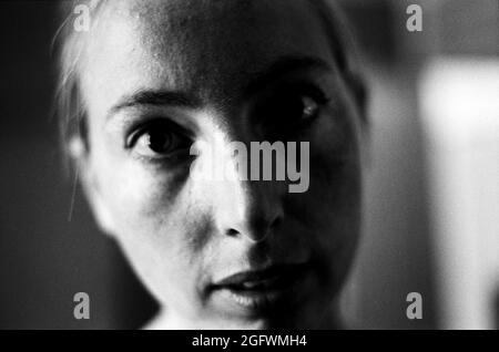 Tilburg, Netherlands. Black & White portrait of a young, caucasian woman. Image shot on analog B&W Kodat T-max film. Stock Photo