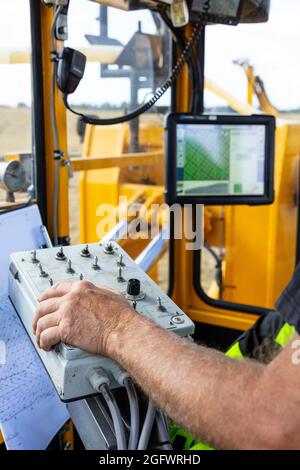 Close-up of male hand operating machine Stock Photo