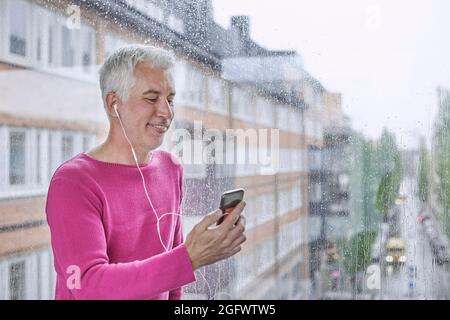 Smiling man having video call via smartphone Stock Photo