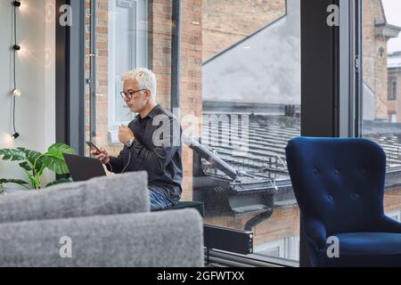 Businessman using laptop and smartphone Stock Photo