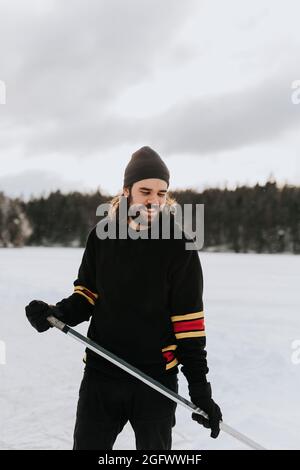 Man standing on frozen lake Stock Photo