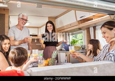 Family having meal in camper van Stock Photo