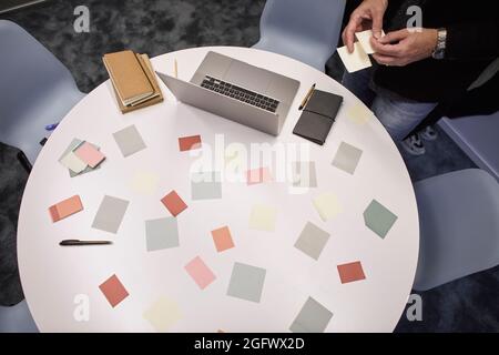 Sticky notes and laptop on table in office Stock Photo