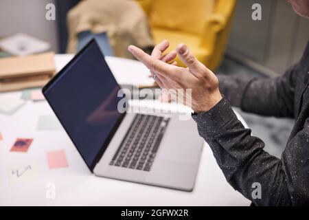 Businessman using laptop in office Stock Photo