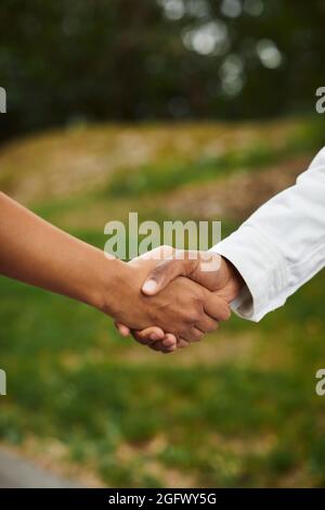 Close-up of people holding hands Stock Photo