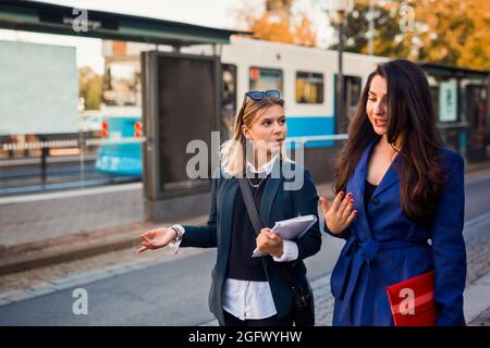 Female coworkers walking together Stock Photo