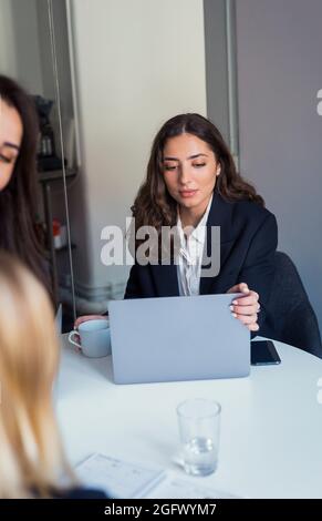 Woman using laptop in office Stock Photo