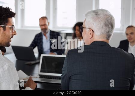 Men talking during business meeting Stock Photo