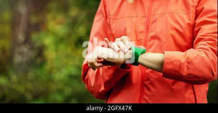 woman checks results on smartwatch after outdoor workout. copy space Stock Photo