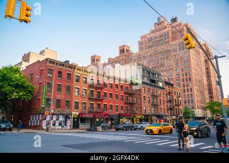 New York City, New York, USA - July 15, 2021:  Street scene from Chelsea neighborhood in Manhattan of intersection with people, buildings and cars. Stock Photo