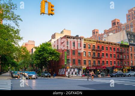 New York City, New York, USA - July 15, 2021:  Street scene from Chelsea neighborhood in Manhattan of intersection with people, buildings and cars. Stock Photo