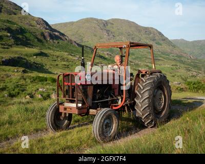 A farmer and his tractor in County Kerry, Ireland. Stock Photo