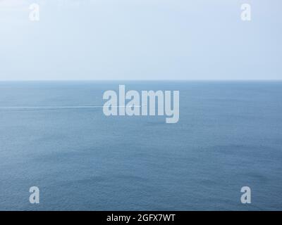 A boat sailing in the Atlantic Ocean off County Clare, Ireland. Stock Photo