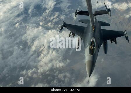 A U.S. Air Force F-16C Fighting Falcon from the 93rd Expeditionary Fighter Squadron, Bagram Airfield, Afghanistan, receives fuel from a KC-10 Extender advanced aerial tanker and cargo aircraft from the 908th Expeditionary Air Refueling Squadron, April 2, 2014. The KC-10 Extender aircrew provided aerial refueling to coalition aircraft operating over Afghanistan for more than eight hours on this single mission in support of Operation Enduring Freedom. The F-16C Fighting Falcon is a compact, multi-role fighter aircraft. It is highly maneuverable and has proven itself in air-to-air combat and air- Stock Photo