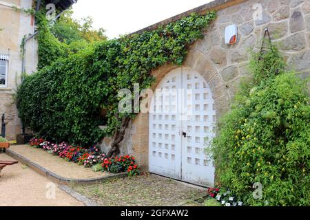 Walled garden within a French village Stock Photo