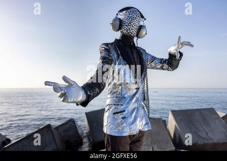 Mr disco man with sparkly face and headphones Stock Photo