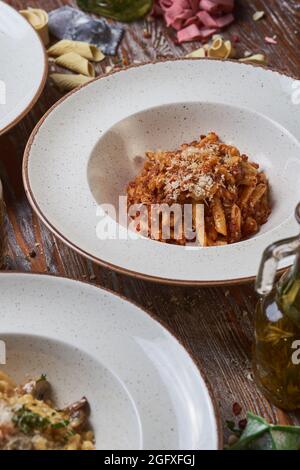 three types of Italian pasta on a wooden table Stock Photo