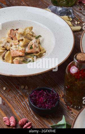 three types of Italian pasta on a wooden table Stock Photo