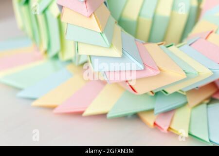 Origami background, parametric structures of colorful paper sheets, close up photo with selective focus Stock Photo