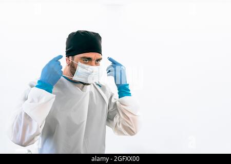 Medical worker wearing surgical face mask preparing for operating room - Healthcare concept Stock Photo