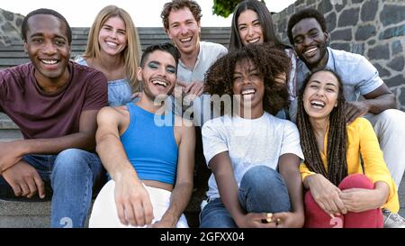 Happy multiracial group of diverse friends hang out in the city - Young people lifestyle concept Stock Photo
