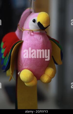 The toy parrot on a branch. Stock Photo