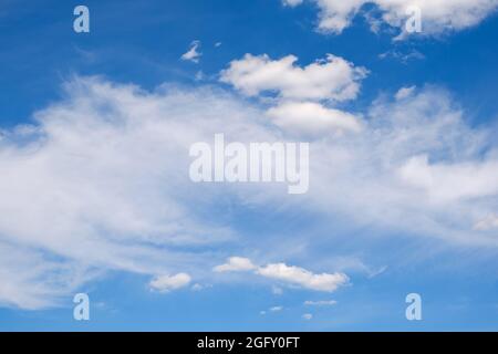 fluffy white clouds on a deep blue sky in summer Stock Photo