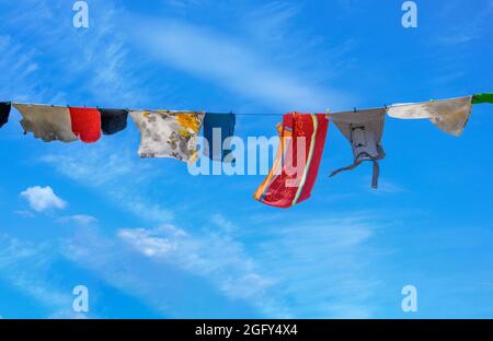 Laundry on a washing line on a windy day. Stock Photo