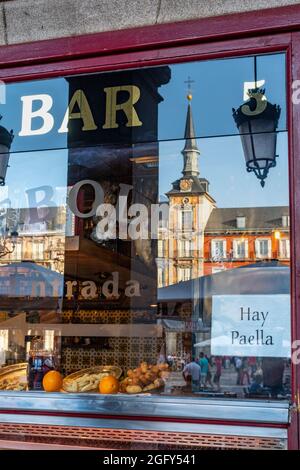 Buildings in the Plaza Mayor reflected in the window of a Cafe and Tapas bar, Plaza Mayor, Central Madrid, Spain Stock Photo