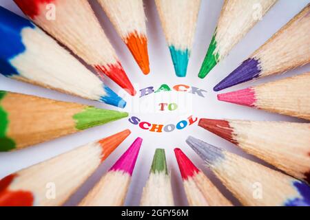 group of coloured pencils arranged in a circle with the tips pointing inwards, selective focus on the tips, horizontal Stock Photo