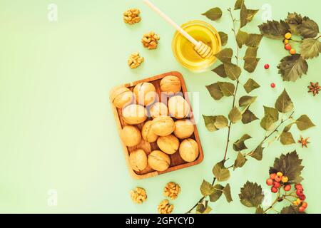 Premium Photo  Useful sweetness, nuts in honey in a glass jar, a man holds  in his hand