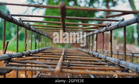 Reinforcing frame of the base plate. Warehouse for building materials for building a house. Rust and corrosion of metal. Stock Photo