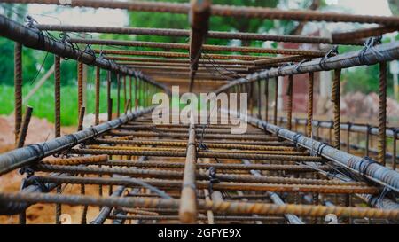 Using steel wire for securing steel bars with wire rod for reinforcement of concrete or cement. focus to steel wire Stock Photo