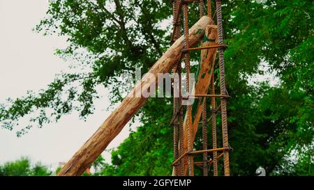 Rusty metal wiring is laid on the ground of house under construction. Preparation for making foundation of a building. Stock Photo