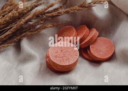 Stack of assorted natural soap bars with lavender on linen textile cloth. Pastel colors Stock Photo