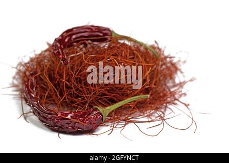 Chilli threads and chilli pod against white background Stock Photo