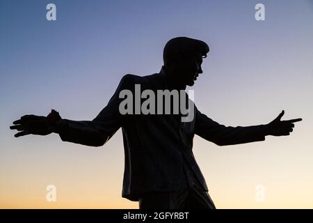 Billy Fury statue on the Liverpool waterfront silhouetted against the setting sun seen in August 2021. Stock Photo