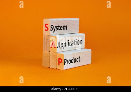 SAP, system, application, product symbol. Wooden blocks with words SAP, system, application, product. Beautiful orange background, copy space. Busines Stock Photo