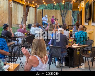 People in a restaurant enjoying musicians on stage Stock Photo